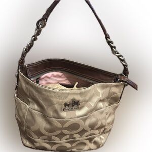 Authentic Coach Tan Signature Shoulder Bag
Has light pink interior